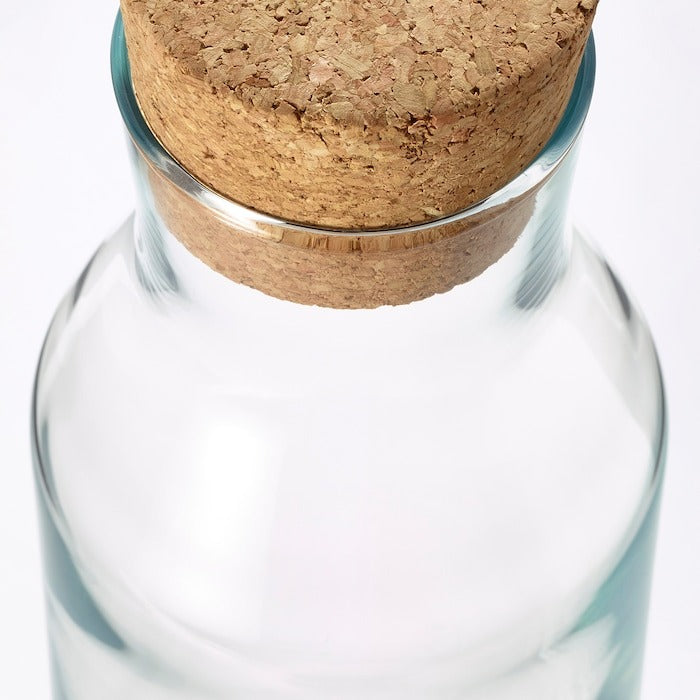 IKEA clear glass carafe 1 L with cork stopper.