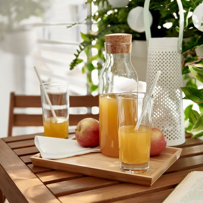 IKEA clear glass carafe 1 L with cork stopper.