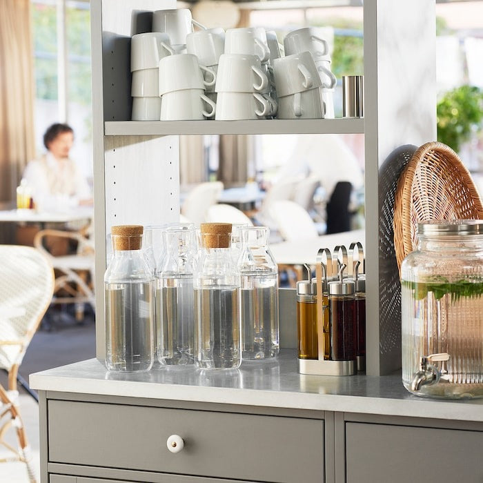 IKEA clear glass carafe 1 L with cork stopper.