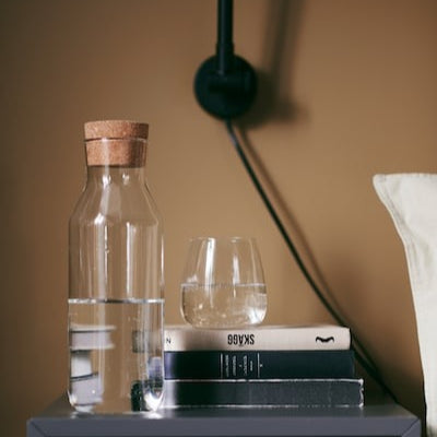 IKEA clear glass carafe 1 L with cork stopper.
