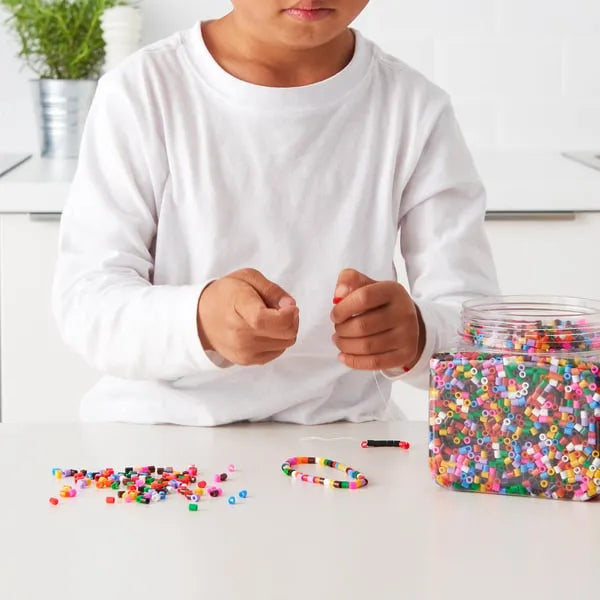 Colourful mixed IKEA PYSSLA beads for DIY art projects.