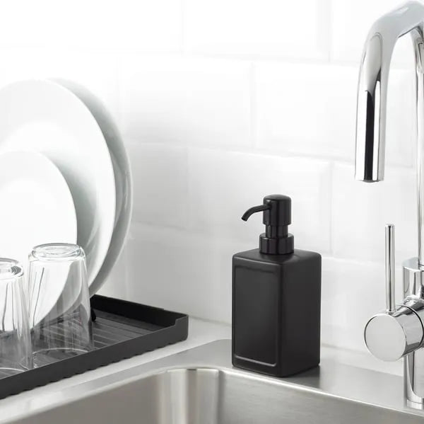 IKEA RINNIG 450 ml grey plastic soap dispenser on sink counter.