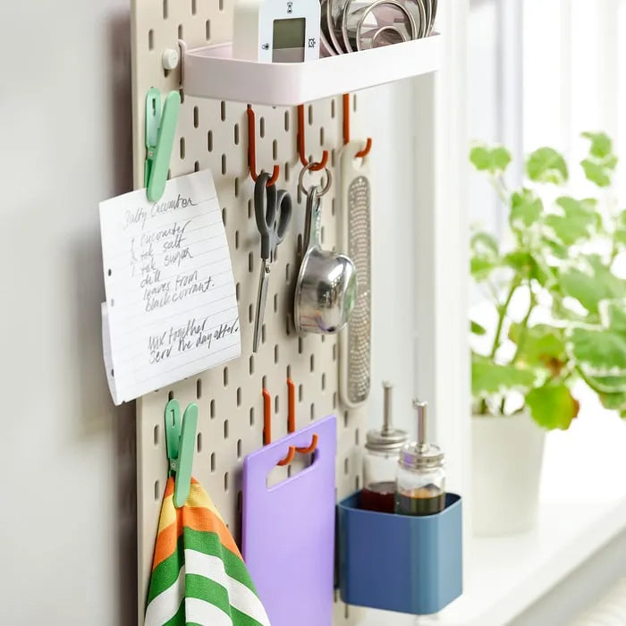 IKEA SKÅDIS series beige pink pegboard for home organization.
