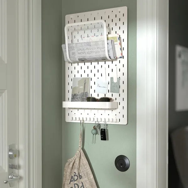 IKEA SKÅDIS white pegboard home organization system.
