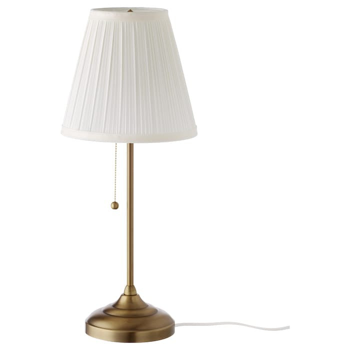 IKEA ARSTID table lamp in gold color.