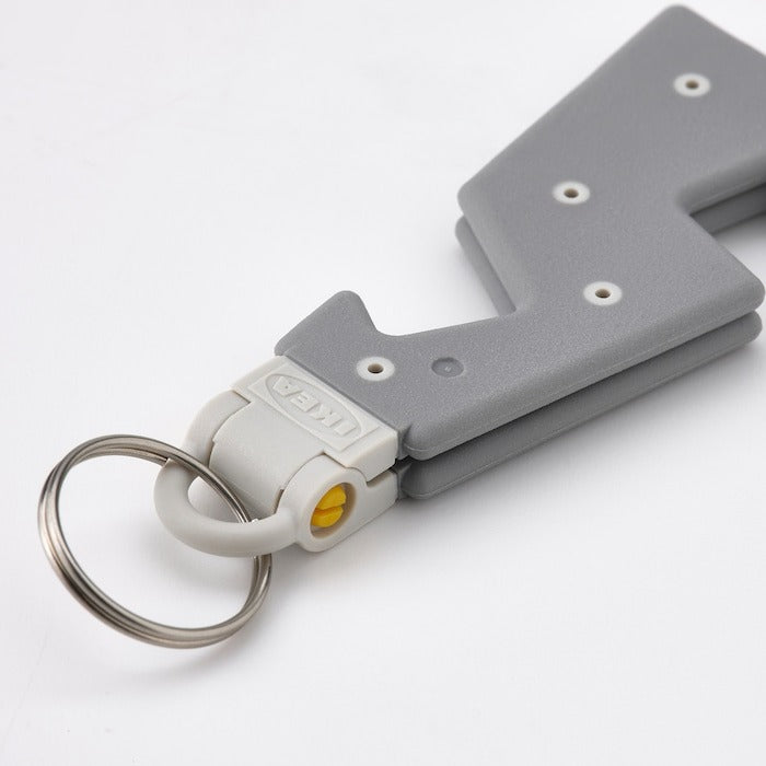 IKEA Holder for mobile phone with key ring in grey color.