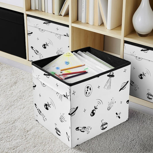 Storage box with black lid and white body featuring black patterns on a carpeted floor.