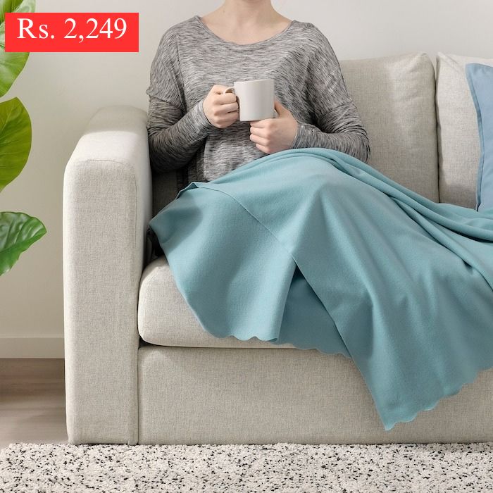 IKEA THROGUN throw for sofa in light blue color.