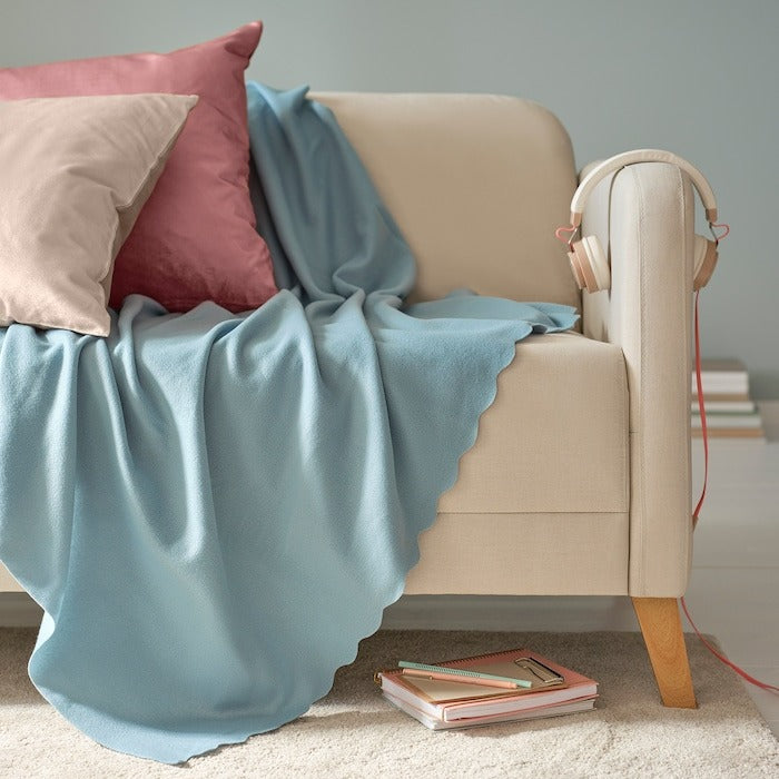 IKEA THROGUN throw for sofa in light blue color.