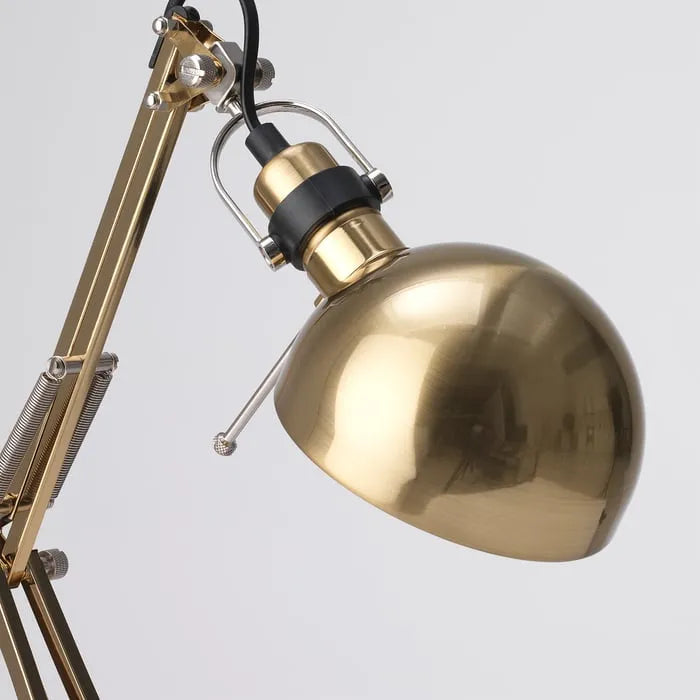 Close-up view of IKEA FORSÅ brass work lamp.