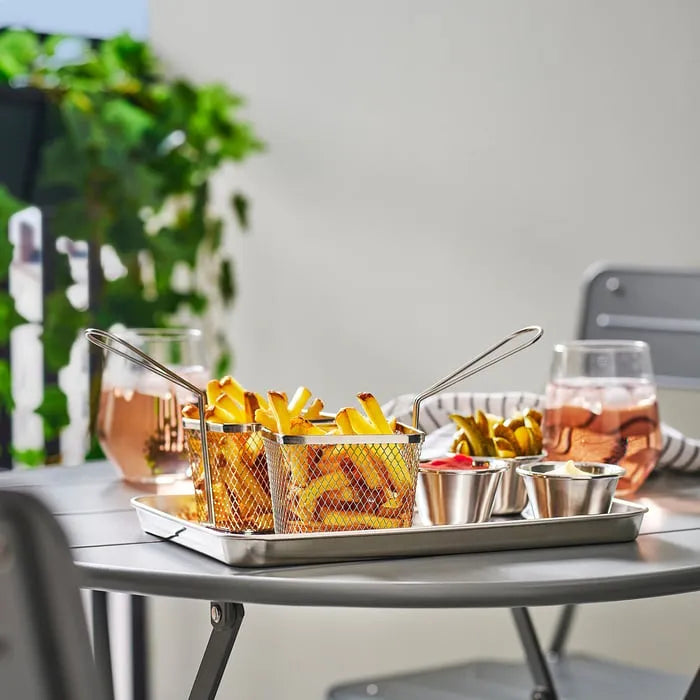 Stainless steel IKEA GRILLTIDER basket on table