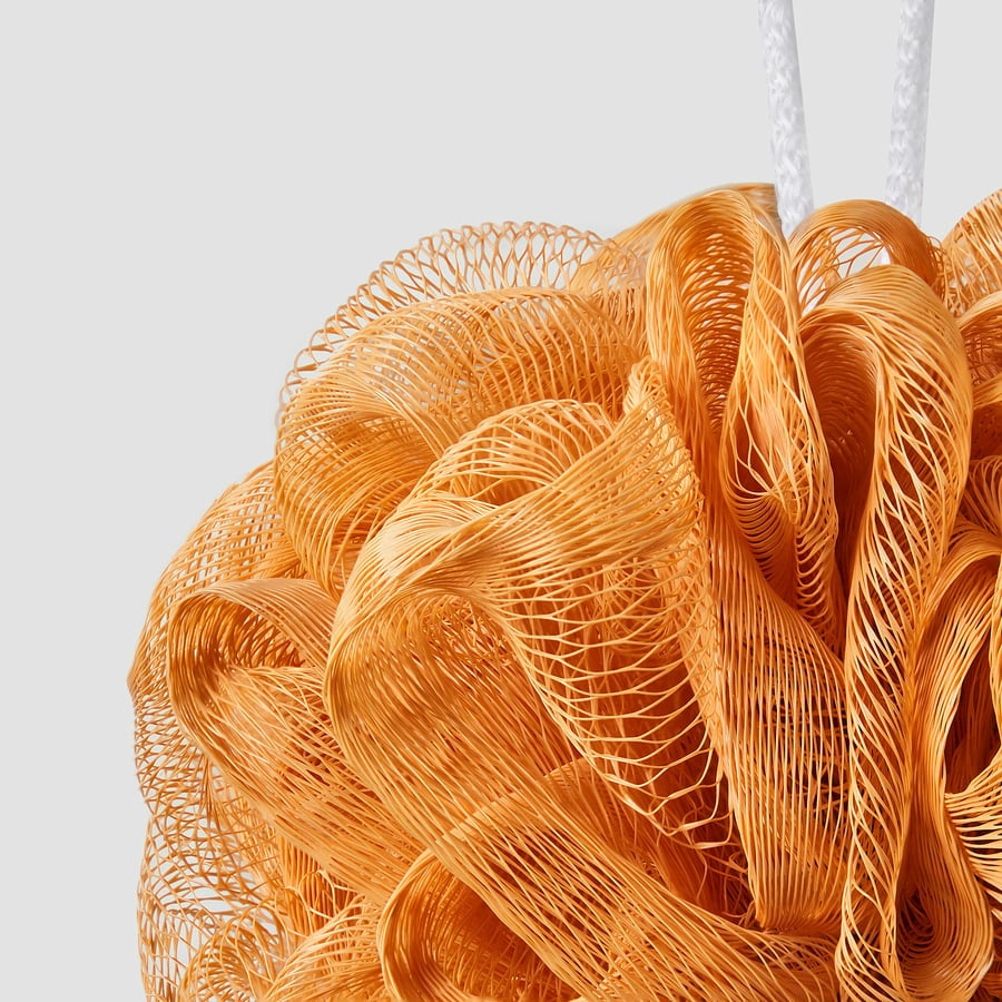 Close-up of IKEA ABYAN body puff texture orange