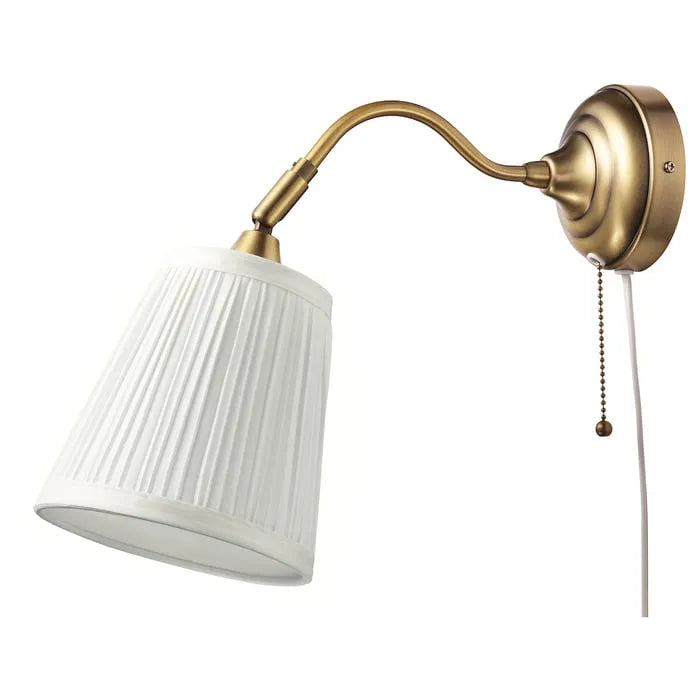 IKEA ÅRSTID wall lamp in brass and white mounted on wall