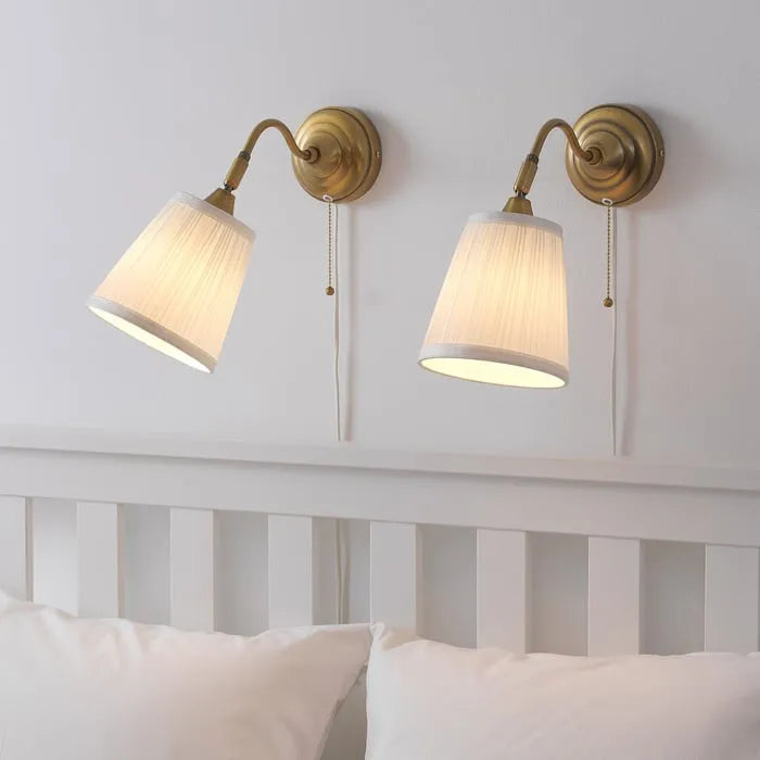 IKEA ÅRSTID wall light used as bedside lamp in bedroom