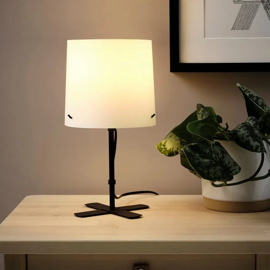 IKEA BARLAST bedside lamp on bedroom side table.