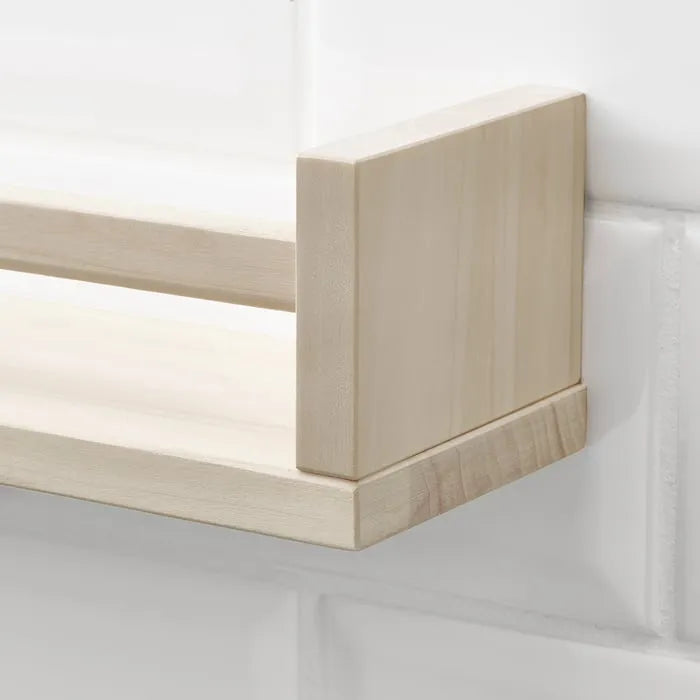 Close-up of IKEA BEKVÄM wooden wall organizer shelf.