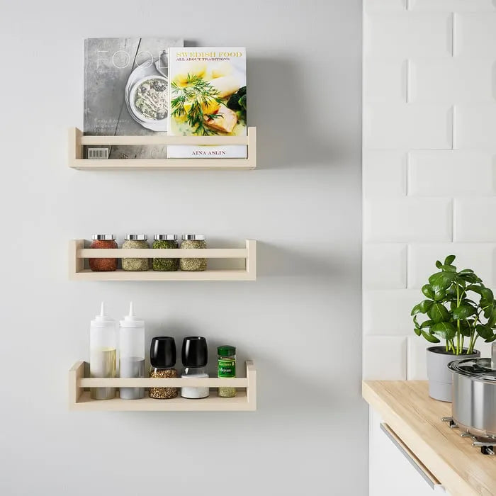 Multiple IKEA BEKVÄM spice racks used together on wall.