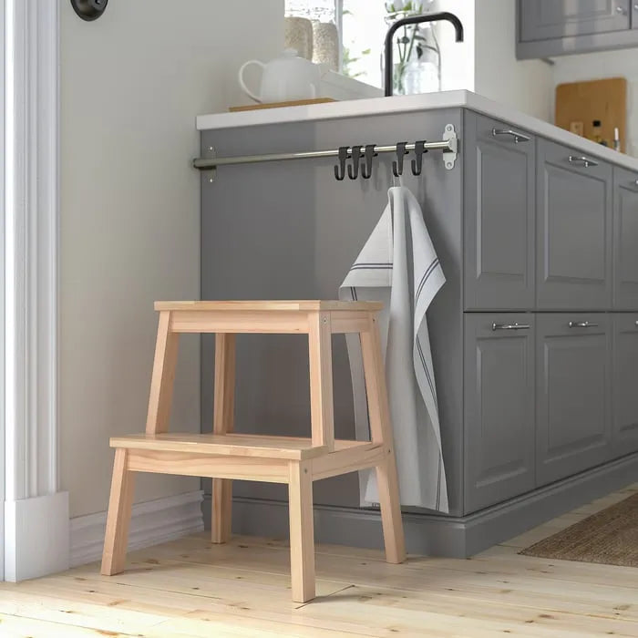 IKEA BEKVAM step stool in kitchen for reaching shelves.