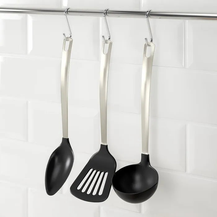 IKEA DIREKT cooking utensils hanging on stand.