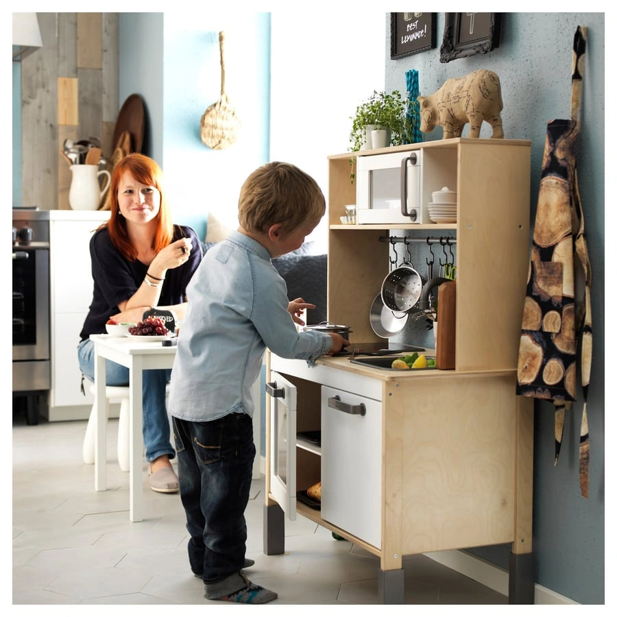 Kids playing with IKEA DUKTIG toy kitchen