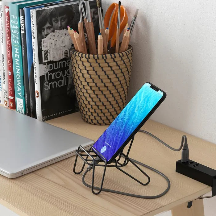 IKEA KRUBBET phone stand placed on office desk.