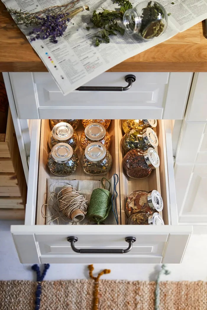 IKEA RAJTAN spice jars neatly arranged in kitchen drawer.