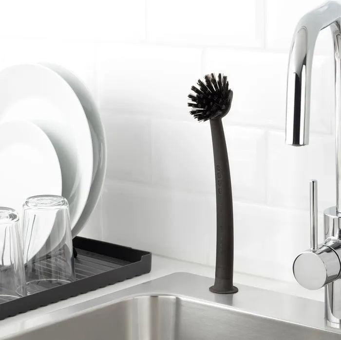 IKEA RINNIG dishwashing brush used in kitchen sink grey.