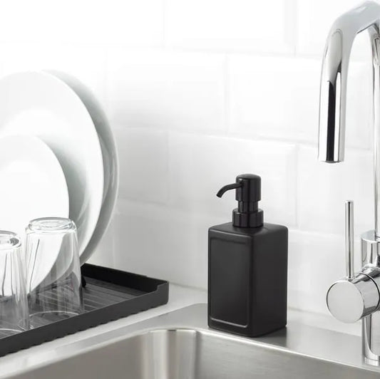 IKEA RINNIG 450 ml grey plastic soap dispenser on sink counter.