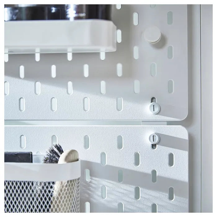 White connector accessory for IKEA SKÅDIS wall pegboard system.