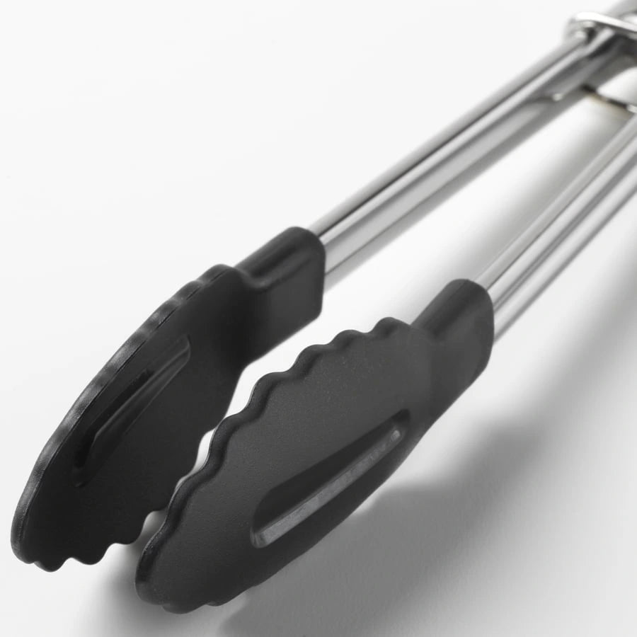 Close-up of IKEA TILLAMPAD stainless steel tongs