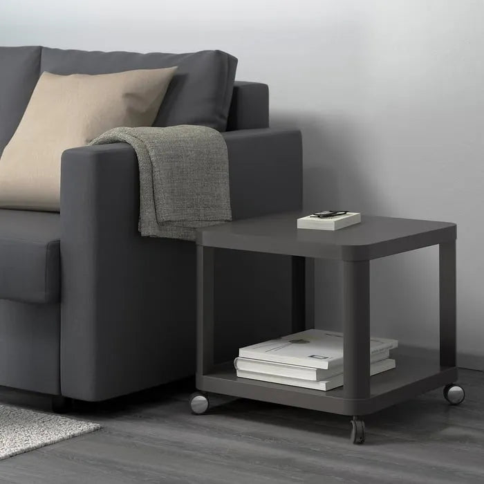 Modern grey IKEA TINGBY mobile side table with wheels.