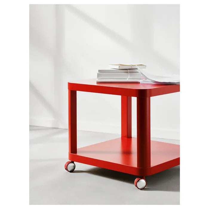 Modern red IKEA TINGBY side table with wheels for small spaces.