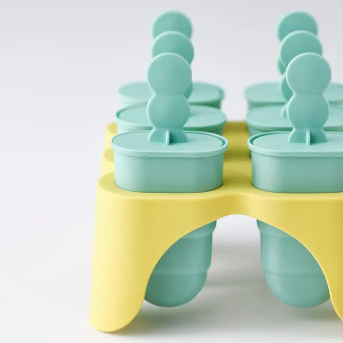 Ice lolly moulds filled with juice and fruit